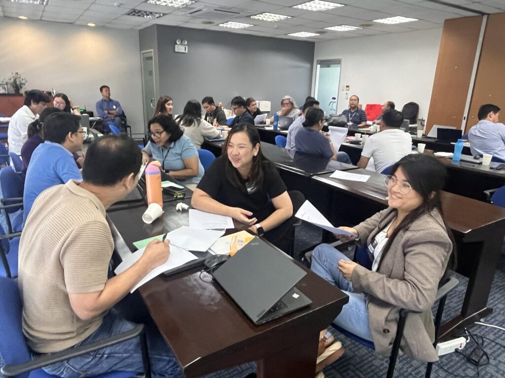 Group of participants working together at tables during a discussion activity