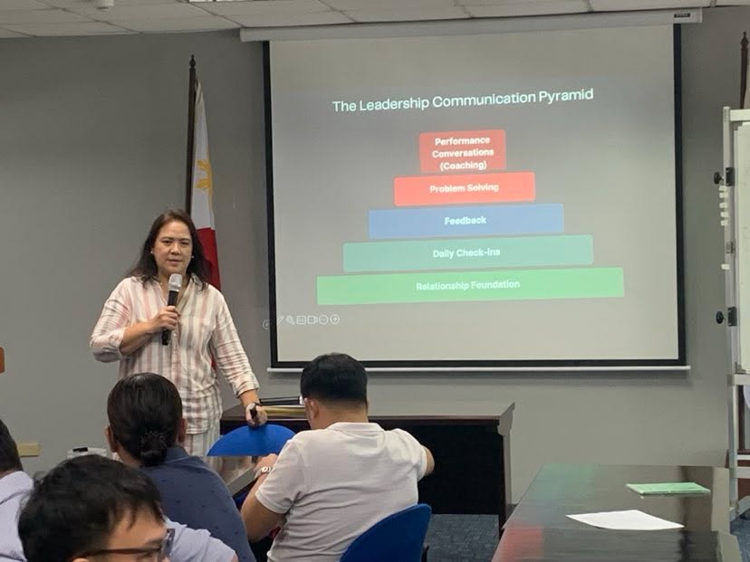 Facilitator , Ms. Gigi Resurreccion presenting "The Leadership Communication Pyramid" slide